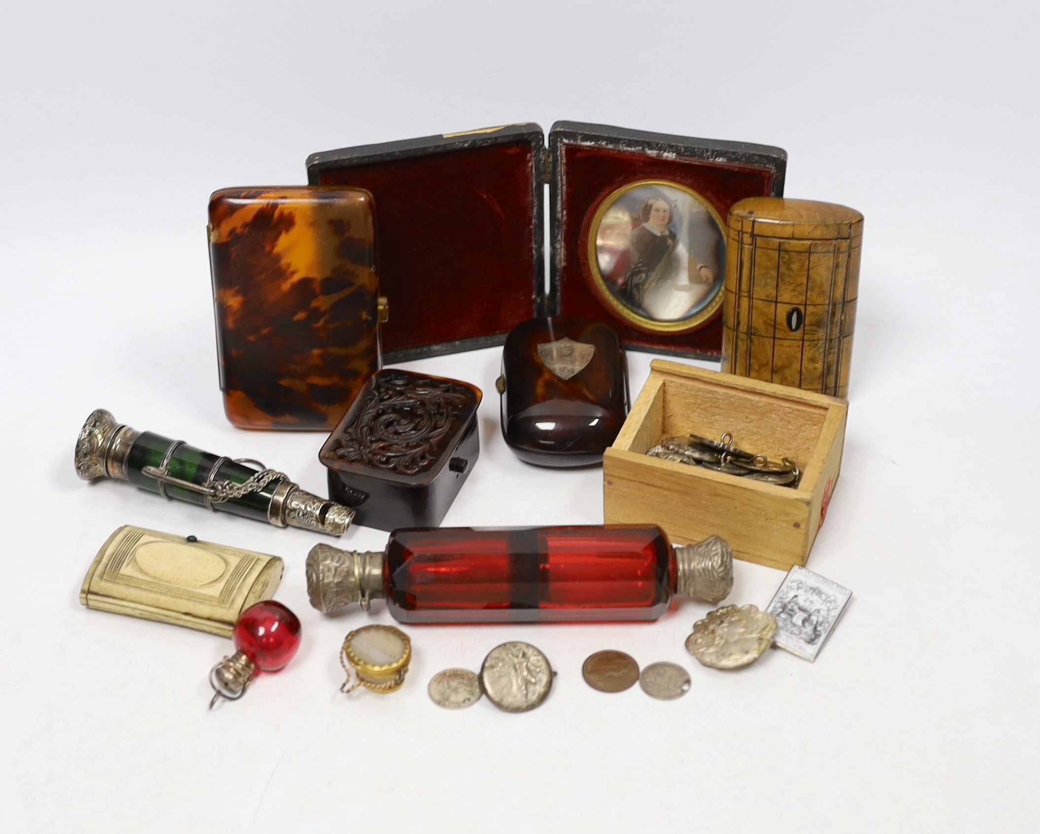 A group of vertu to include an unusual Victorian white metal mounted green glass combination scent bottle and whistle, a group of Art Nouveau silver buttons, carved tortoiseshell boxes, a double ended scent bottle etc.